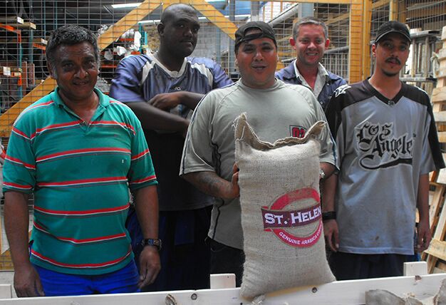Coffee farmers holding a sack of St Helena coffee beans