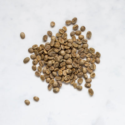 Unroasted green coffee beans on a marble background
