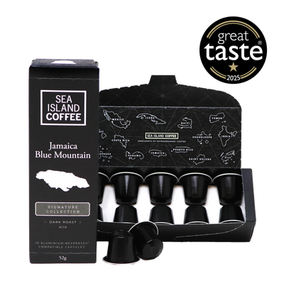 Product shot of some Jamaica Blue Mountain Nespresso compatible coffee pods in black dark roast capsules