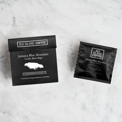 Sea Island Coffee Jamaica Blue Mountain coffee brew bags on a marble surface.