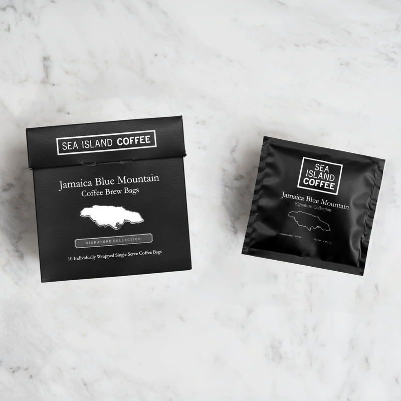 Sea Island Coffee Jamaica Blue Mountain coffee brew bags on a marble surface.