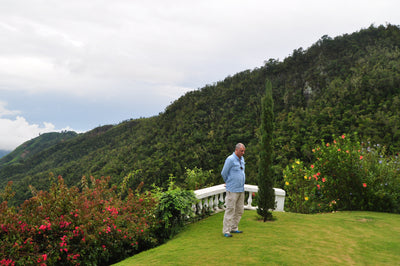 Clifton Mount estate owner standing in the garden next to the Jamaican Blue Mountains