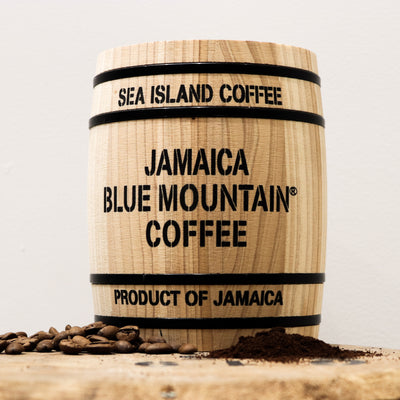 A gift barrel of Jamaican Blue Mountain coffee beans sitting on a bigger barrel