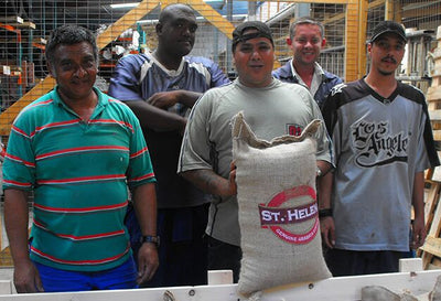 St Helena coffee pickers holding a sack of St Helena coffee beans